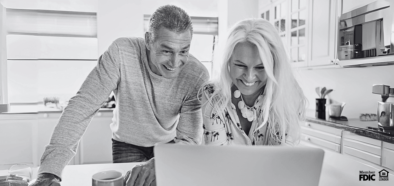 a middle aged man and woman invest their tax return using online banking.